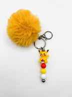 Porte-clés figurine pikachu avec pompon moutarde