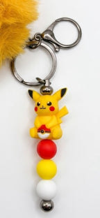 Porte-clés figurine pikachu avec pompon moutarde